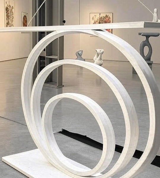 The Modern Concentric Ring Sculpture with Figurines is a bold, hangable art piece featuring suspended concentric rings and minimal figurines